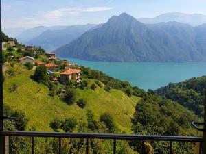 a view of a lake on a hill with a house at Soffio Di Rugiada in Fonteno