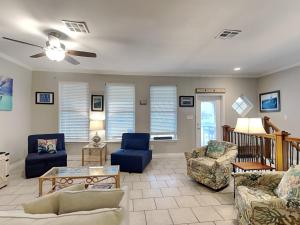 a living room with couches and chairs at 3 Sheets To the Zin in Port Aransas