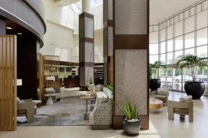 a lobby with chairs and tables in a building at The Westin Fort Lauderdale in Fort Lauderdale