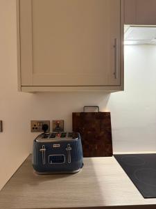 a suitcase sitting on a counter in a kitchen at West Riverside Farm in Stirling