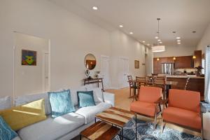 a living room with a couch and chairs and a kitchen at Dwell 30 Day Minimum in Bend