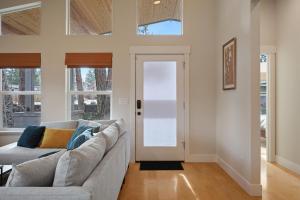 a living room with a couch and a door at Dwell 30 Day Minimum in Bend