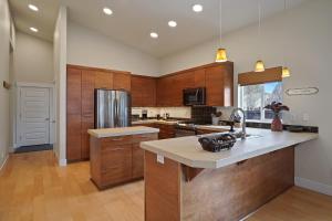 a large kitchen with wooden cabinets and a counter top at Dwell 30 Day Minimum in Bend