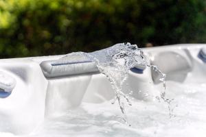 a bath tub with water pouring out of it at Reethaus Remy Luxus In Beckerwitz in Gramkow