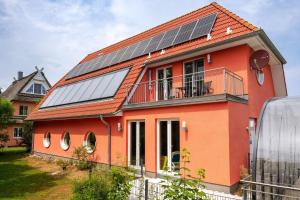 a house with solar panels on the roof at Reethaus Remy Luxus In Beckerwitz in Gramkow