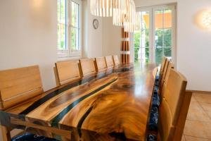 a large wooden table in a room with a dining room at Reethaus Remy Luxus In Beckerwitz in Gramkow