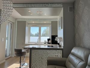 a living room with a table and a couch at AKOYA APARTMENT Cristal Bianco in Koszalin