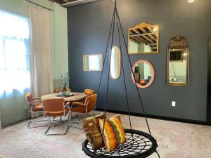 a living room with a table and a swing at Downtown Lynchburg REAL loft living Va Virginia in Lynchburg