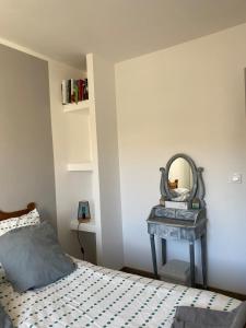 a bedroom with a bed and a mirror on a table at Maison 4 personnes Sorède in Sorède