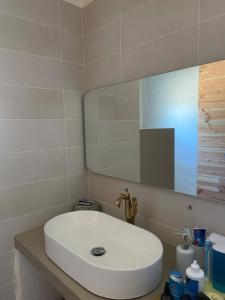 a bathroom with a white sink and a mirror at Maison 4 personnes Sorède in Sorède
