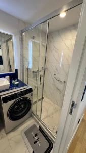 Orbi city mia luxury studio في باتومي: وجود غسالة في الحمام مع دش +9 صور