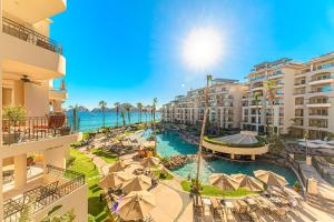 an aerial view of a resort with a pool and the ocean at Villa La Estancia in Cabo San Lucas