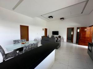 a living room with a table and chairs at Casa Parque das Árvores in Camaçari