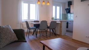 a living room with a table and chairs and a kitchen at Tom s Apartment I in Knittelfeld