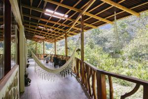a hammock on a porch of a house at Mandor Machu Picchu in Machu Picchu