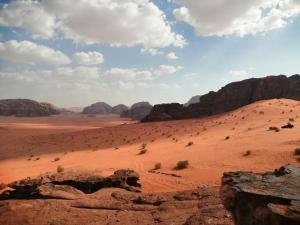 a view of the desert with mountains and rocks at Wadi Rum Thamer in Wadi Rum