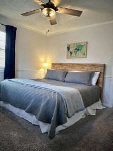 a bedroom with a bed with a ceiling fan at Cozy Bungalow 3bdrm 2 and a half bath Hot Tub in Little Rock