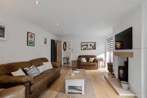 a living room with a couch and a fireplace at Evergreen Eco House - Allocated parking, Ancillary accommodation in Ripon