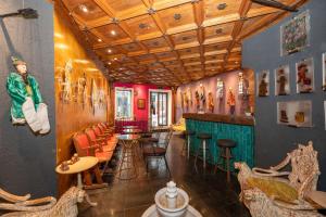 a restaurant with a bar with chairs and tables at TaksimAntiqueOtel in Istanbul
