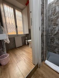 a bathroom with a glass shower and a toilet at My Friends in Florence