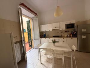 a kitchen with a table and chairs and a refrigerator at My Friends in Florence