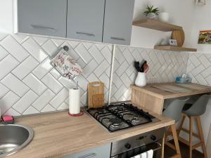 a kitchen with a stove and a counter top at VYO Studio in Braşov