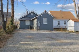 a blue house with a driveway in front of it at Lively Bungalow Retreat Near Belle Isle, RVA! in Richmond