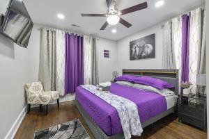 a bedroom with a purple bed and a ceiling fan at Lively Bungalow Retreat Near Belle Isle, RVA! in Richmond