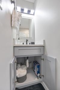 a bathroom with a sink and a mirror at Lively Bungalow Retreat Near Belle Isle, RVA! in Richmond