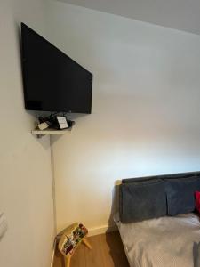 a flat screen tv hanging on a wall at Bliss city apartments-Taurunum 1 in Belgrade