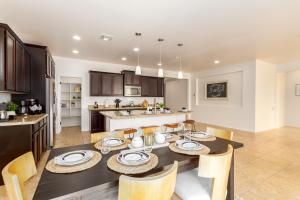a kitchen and dining room with a table and chairs at Dapple Gray Queen Creek in Queen Creek