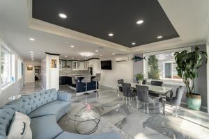 a living room with a blue couch and a dining room at the bachelorette in North Beach