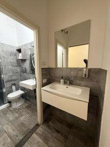 a bathroom with a sink and a toilet and a mirror at My Friends in Florence