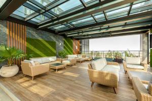 a lobby with couches and chairs in a building at Sky Suites-KASS Towers in Okponglo