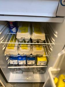 an open refrigerator filled with eggs and milk at My Friends in Florence
