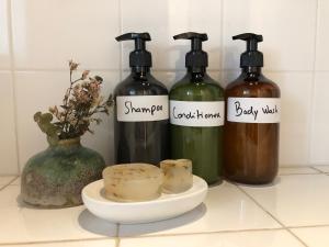 a group of three bottles of wine on a counter at Refúgio da Alma in Mafra