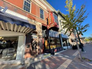 a street scene of a store on a city street at Stunning Studio Overlooking Main Street Parkade! in Cedar Falls
