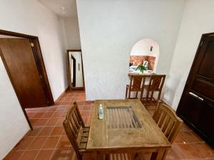 a dining room with a wooden table and chairs at Bungalow Tepoztlán in Tepoztlán