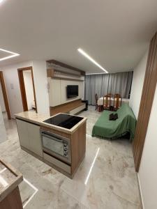 a kitchen with a stove top oven in a room at Seu apartamento frente mar in Vila Velha
