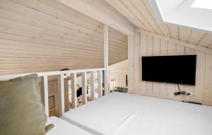 a room with a flat screen tv on a wall at 3 Bedroom Lovely Home In Nexø in Neksø +18 photos
