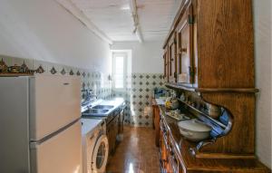 a kitchen with wooden cabinets and a refrigerator at 3 Bedroom Nice Apartment In Stazzema in Stazzema