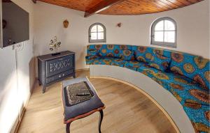 a living room with a couch with a stove at Villa Avec Piscine Privée in Saint-Jean-de-Monts