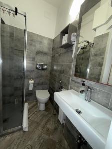 a bathroom with a sink and a toilet and a shower at My Friends in Florence