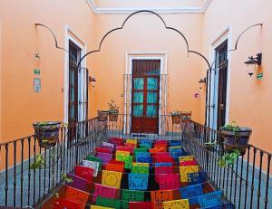 a colorful rug on the stairs of a building at Hotel del Capitán de Puebla in Puebla