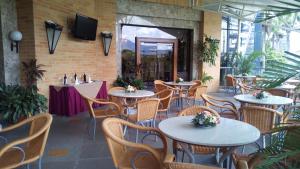 a restaurant with tables and chairs and a tv on the wall at Hotel Cristal Park in Valencia