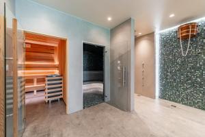 a bedroom with a walk in closet and a shower at 408 - Apartament Zakopiański z balkonem - Sauna & Jacuzzi & Plac zabaw & Siłownia in Zakopane +37 photos