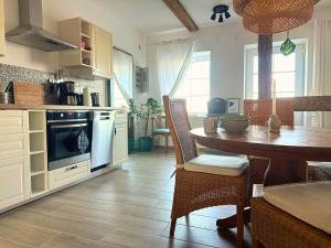 a kitchen with a table and a dining room at Fischerhus in Rieseby