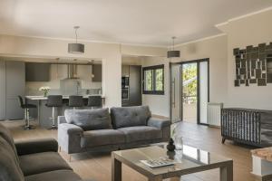 a living room with a couch and a table at Villa Astoria Exclusive luxury villa in Svoronata with breathtaking views and private grounds in Kefallonia