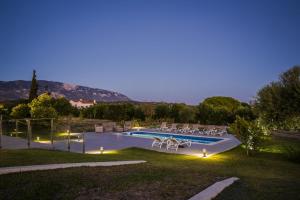 a villa with a swimming pool at night at Villa Astoria Exclusive luxury villa in Svoronata with breathtaking views and private grounds in Kefallonia