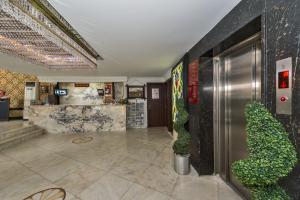 a lobby of a hotel with a counter and plants at Kuran Hotel International in Istanbul